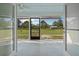 Screened-in porch with ceiling fan and backyard views at 7729 Lake Andrea Cir, Mount Dora, FL 32757