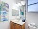 Bright bathroom featuring a large vanity with a mirror, artistic wall decor and natural light at 9113 Sw 91St Court Rd, Ocala, FL 34481