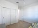 A bedroom with a daybed, gray nightstand and closet; a hallway can be seen through a door at 9113 Sw 91St Court Rd, Ocala, FL 34481