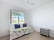 Bright bedroom features a daybed under a large window and gray nightstand at 9113 Sw 91St Court Rd, Ocala, FL 34481