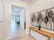 Wide foyer with tiled floors, decorative wall art, table, and views to dining area at 9113 Sw 91St Court Rd, Ocala, FL 34481