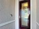 Close up of glass front door with visible Ring doorbell on textured exterior wall at 9113 Sw 91St Court Rd, Ocala, FL 34481