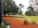Well-maintained front yard featuring mature trees and lush greenery at 9113 Sw 91St Court Rd, Ocala, FL 34481