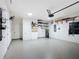 Well-organized garage with epoxy floor, storage shelves, hot water tank, and white painted walls at 9113 Sw 91St Court Rd, Ocala, FL 34481