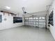 Spacious two-car garage with epoxy flooring, wall-mounted storage racks, and an automatic door opener at 9113 Sw 91St Court Rd, Ocala, FL 34481