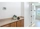 Hallway with natural lighting, built in shelves, cabinets, and views of the outside at 9113 Sw 91St Court Rd, Ocala, FL 34481