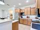 Bright kitchen with stainless steel appliances, wooden cabinets, and a view of the foyer at 9113 Sw 91St Court Rd, Ocala, FL 34481