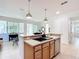 Open kitchen with a breakfast bar, stainless steel appliances, and view into the living area at 9113 Sw 91St Court Rd, Ocala, FL 34481