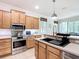 Kitchen features stainless steel appliances, wooden cabinets, and a breakfast bar counter at 9113 Sw 91St Court Rd, Ocala, FL 34481