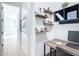 Hallway leading to the modern office space with floating shelves, a desk and computer equipment at 9113 Sw 91St Court Rd, Ocala, FL 34481