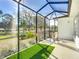 Relaxing screened-in patio with a seating area, hanging plants, and overlooking the green outdoors at 9113 Sw 91St Court Rd, Ocala, FL 34481