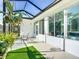 Inviting screened patio with cozy furniture, hanging plants, and natural light streaming through at 9113 Sw 91St Court Rd, Ocala, FL 34481