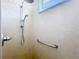 Shower with adjustable shower head, grab bar and light marble look on shower walls at 9113 Sw 91St Court Rd, Ocala, FL 34481