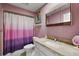 Pink bathroom with vanity, sink, and shower tub combo with updated fixtures at 100 S Tremain St # G1, Mount Dora, FL 32757