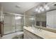 Well-lit bathroom featuring a shower with glass doors and a granite vanity at 100 S Tremain St # G1, Mount Dora, FL 32757