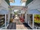 Enchanting walkway through shops with unique storefronts, offering a delightful retail experience in a charming setting at 100 S Tremain St # G1, Mount Dora, FL 32757