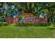 Welcome to Mount Dora sign featuring a brick base and lush greenery at 100 S Tremain St # G1, Mount Dora, FL 32757