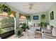 Bright sun room filled with potted plants and an abundance of natural light at 100 S Tremain St # G1, Mount Dora, FL 32757