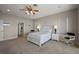 Spacious bedroom with neutral tones, ceiling fan, and an ensuite bathroom at 10610 Masters Dr, Clermont, FL 34711