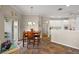 Charming dining area adjacent to the kitchen features a cozy breakfast nook and sliding glass doors at 10610 Masters Dr, Clermont, FL 34711