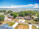 Aerial shot of a lakeside neighborhood showcasing homes, streets, and surrounding natural beauty at 1108 Cedar St, Leesburg, FL 34748