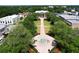 Aerial view features a beautifully landscaped walkway leading to an elegant government building with lush greenery and a fountain at 1108 Cedar St, Leesburg, FL 34748