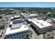 An aerial view features a commercial area with mixed-use buildings and streets at 1108 Cedar St, Leesburg, FL 34748