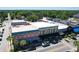 Aerial view highlights commercial buildings, showing architectural details along a bustling city street at 1108 Cedar St, Leesburg, FL 34748