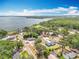 Stunning aerial view of lakeside homes surrounded by lush trees under a partly cloudy sky at 1108 Cedar St, Leesburg, FL 34748