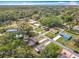 An aerial view of a neighborhood with a mixture of houses, trees, and visible roads, on a sunny day at 1108 Cedar St, Leesburg, FL 34748