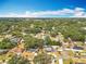 Picturesque aerial view showcasing homes amid lush greenery with a cloudy sky background at 1108 Cedar St, Leesburg, FL 34748
