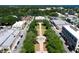 Aerial view features a beautifully landscaped walkway leading to an elegant government building with lush greenery and a fountain at 1108 Cedar St, Leesburg, FL 34748