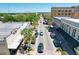 Aerial view of a commercial street with buildings, palm trees, and vehicular traffic on a bright, sunny day at 1108 Cedar St, Leesburg, FL 34748