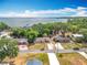 Drone view of a residential area with nearby lake access and well-kept properties at 1108 Cedar St, Leesburg, FL 34748