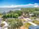 Aerial view of a neighborhood with houses and lush trees close to a large lake at 1108 Cedar St, Leesburg, FL 34748