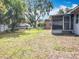 Spacious backyard with green lawn, boat storage, and a screened in porch at 1108 Cedar St, Leesburg, FL 34748