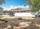 View of backyard, showcasing a patio with a fire pit and an enclosed porch at 1108 Cedar St, Leesburg, FL 34748