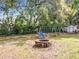 Enjoy a backyard with a playground set and brick fire pit at 1108 Cedar St, Leesburg, FL 34748