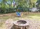 Backyard includes a brick fire pit, playground set and storage shed at 1108 Cedar St, Leesburg, FL 34748