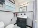 Traditional bathroom with black and white tiling, vanity with black cabinetry, and a shower/tub with curtain at 1108 Cedar St, Leesburg, FL 34748