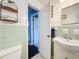 Traditional bathroom featuring light green tile, standard fixtures, and a patterned shower curtain at 1108 Cedar St, Leesburg, FL 34748