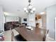 Open-concept dining area connecting the living room and kitchen, with a modern chandelier at 1108 Cedar St, Leesburg, FL 34748