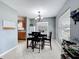 Bright dining room area with a view into the adjacent kitchen, features tile flooring at 1108 Cedar St, Leesburg, FL 34748