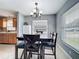 Bright dining room with tile flooring and a clear view into the adjacent kitchen at 1108 Cedar St, Leesburg, FL 34748