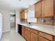 Traditional kitchen featuring wood cabinets, tile floors, and stainless steel sink at 1108 Cedar St, Leesburg, FL 34748