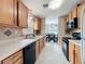 Traditional kitchen featuring wood cabinets, tile floors, and view to the dining room at 1108 Cedar St, Leesburg, FL 34748