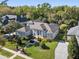 Aerial view of a beautifully landscaped home surrounded by lush trees, highlighting the well-manicured lawn at 114 Cherry Creek Cir, Winter Springs, FL 32708