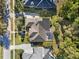 From above, see the home's solar panels, screened-in porch, and well-manicured landscaping at 114 Cherry Creek Cir, Winter Springs, FL 32708