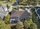 Aerial view showcasing solar panels, screen patio, and well maintained landscape at 114 Cherry Creek Cir, Winter Springs, FL 32708