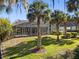 A spacious screened-in lanai and fenced yard are surrounded by swaying palm trees at 114 Cherry Creek Cir, Winter Springs, FL 32708